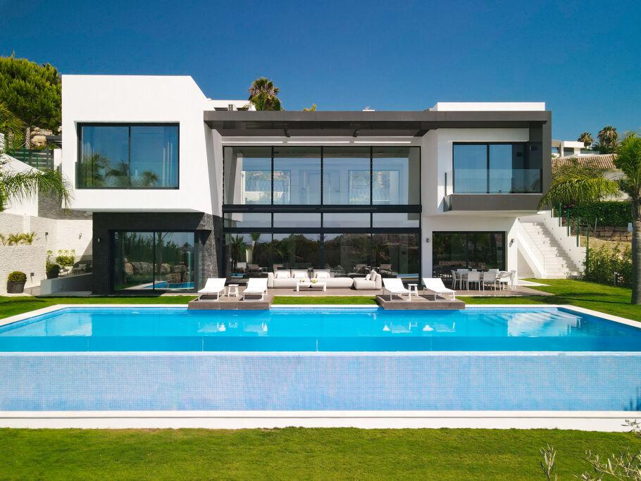 Contemporary private villa with full-height windows and a swimming pool